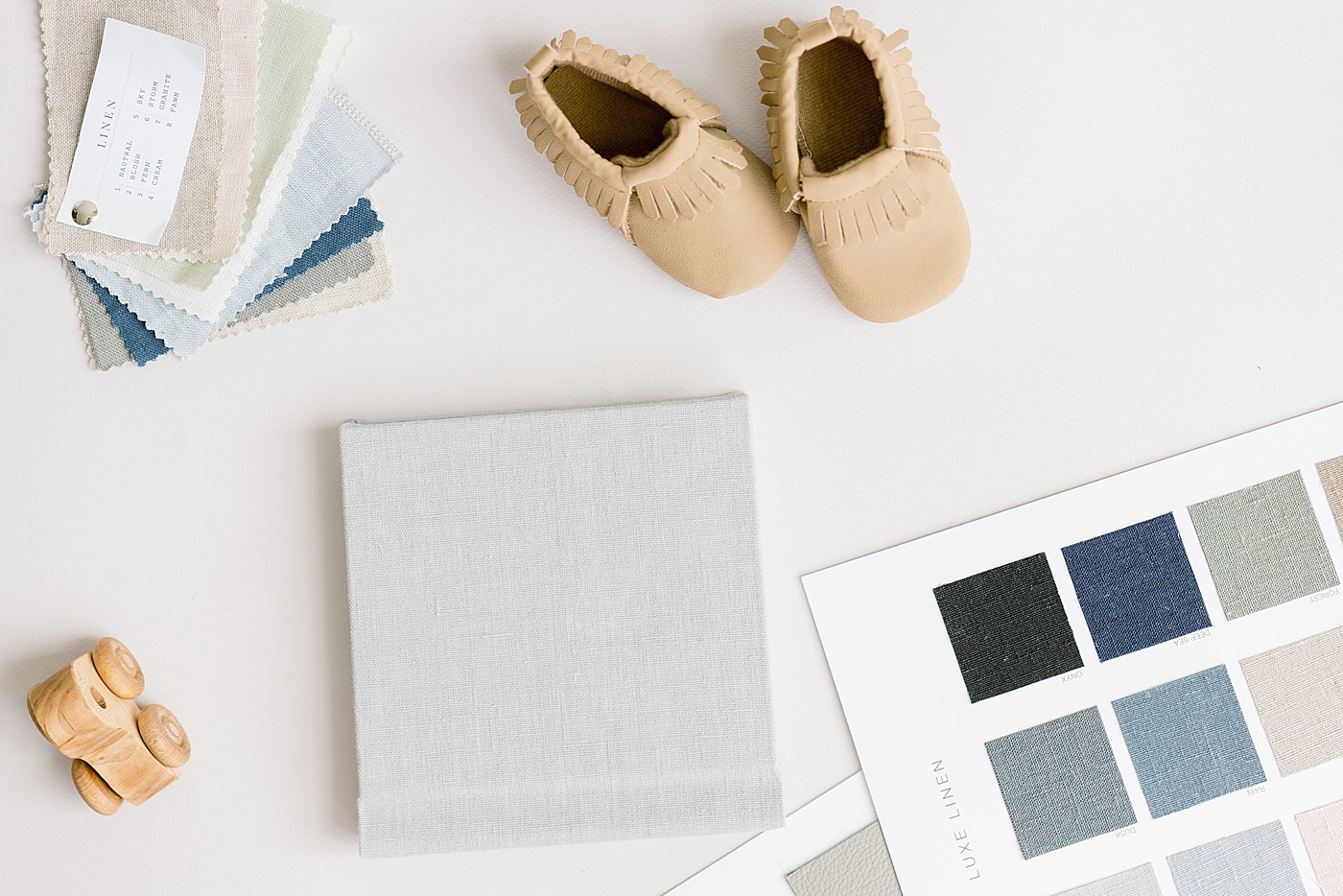 Baby shoes and album swatches | Full Service Newborn Photographer Sana Ahmed 