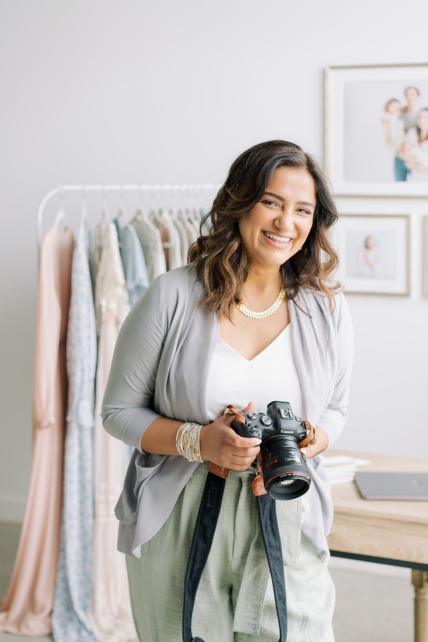 Smiling photographer holding her camera | Sana Ahmed Photography