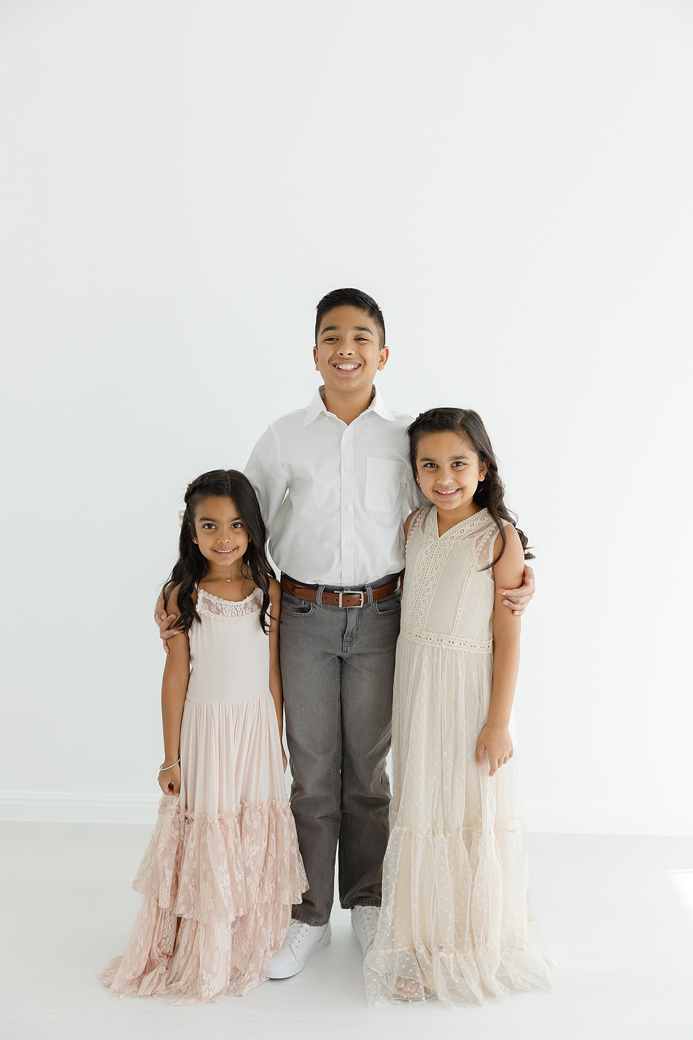 Brother with his two sisters in the studio | Image by Sana Ahmed Photography