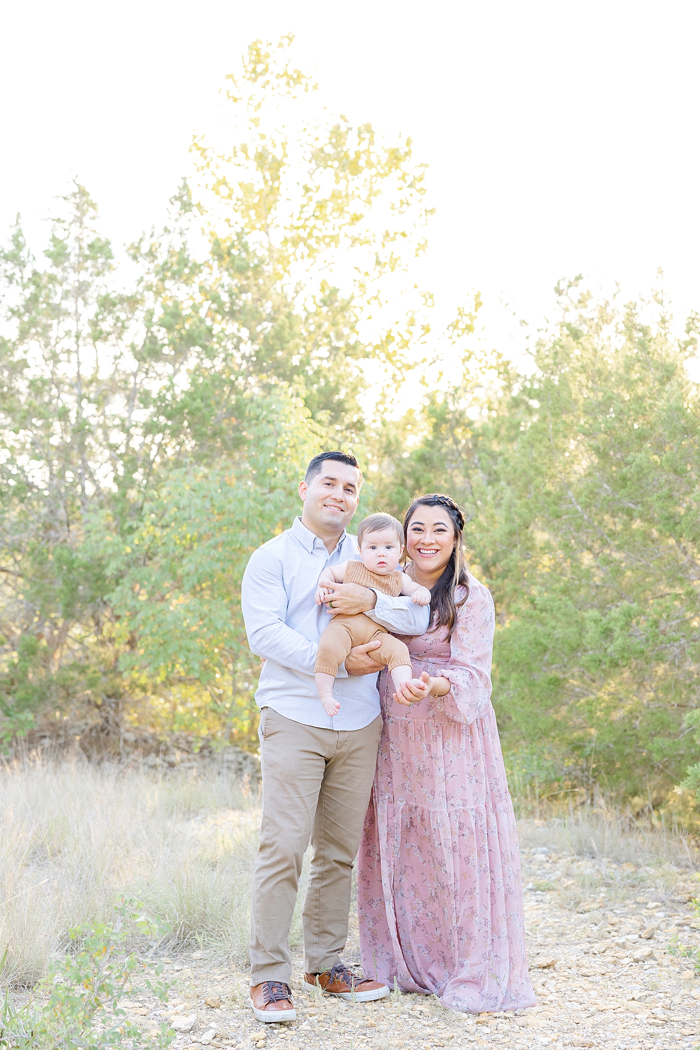 Mom and dad holding their baby boy during Six Month Milestone Session | Image by Sana Ahmed Photography