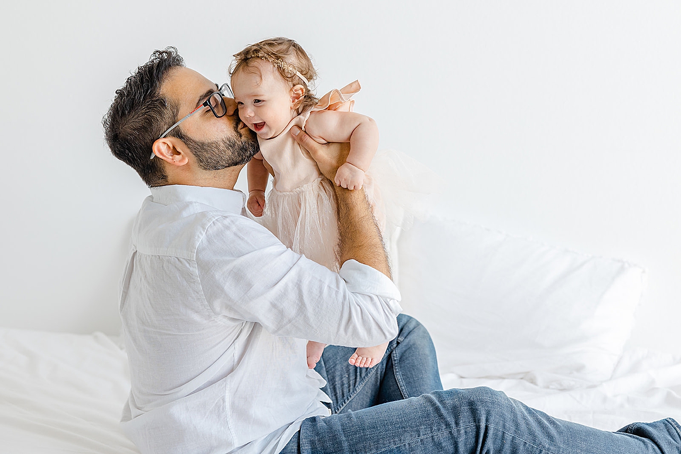 Dad kissing his baby girl | Image by Sana Ahmed Photography