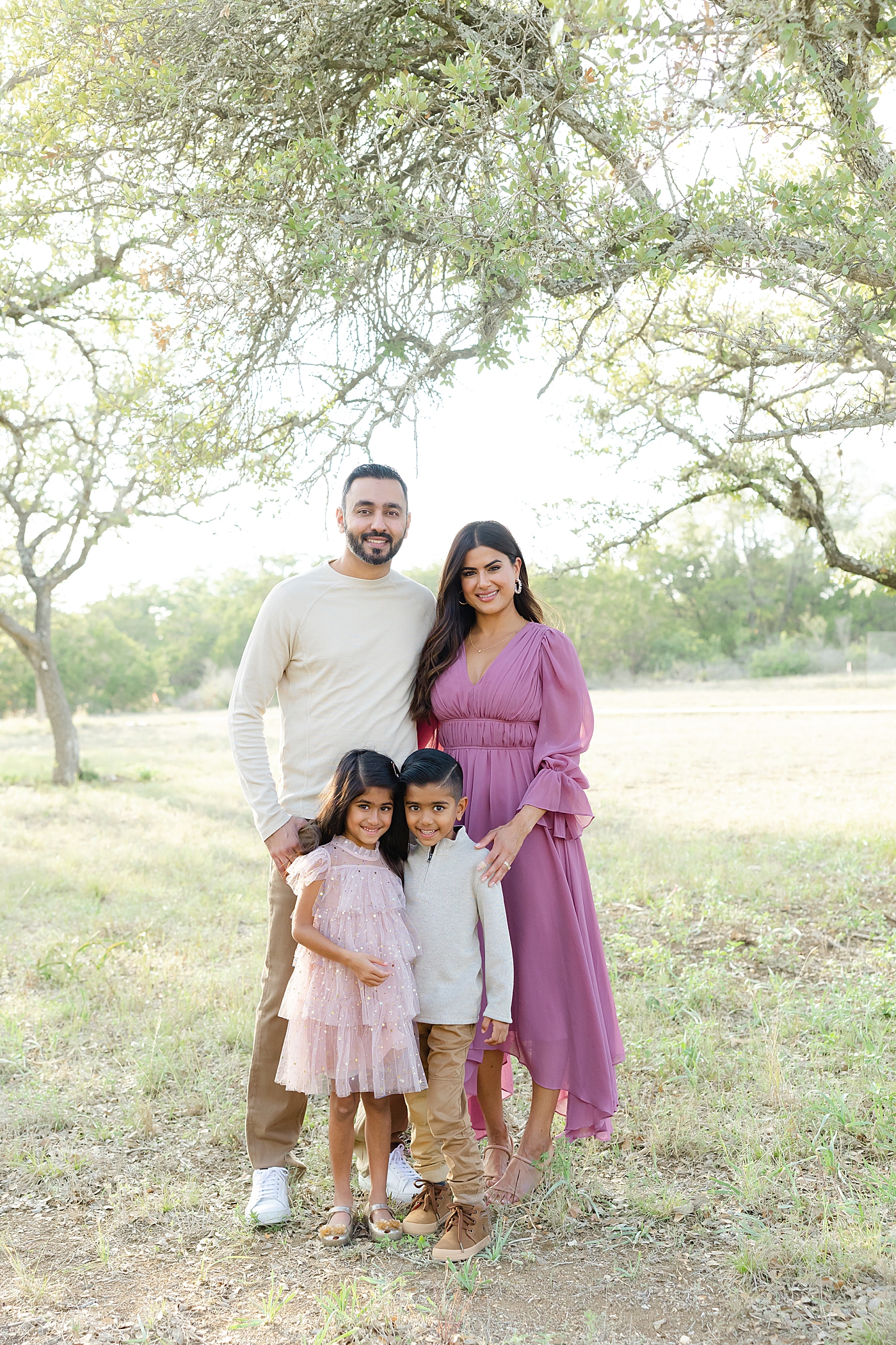 Mom and dad posing with their two kids | Field Family Session in Austin with Twins with Sana Ahmed Photography 