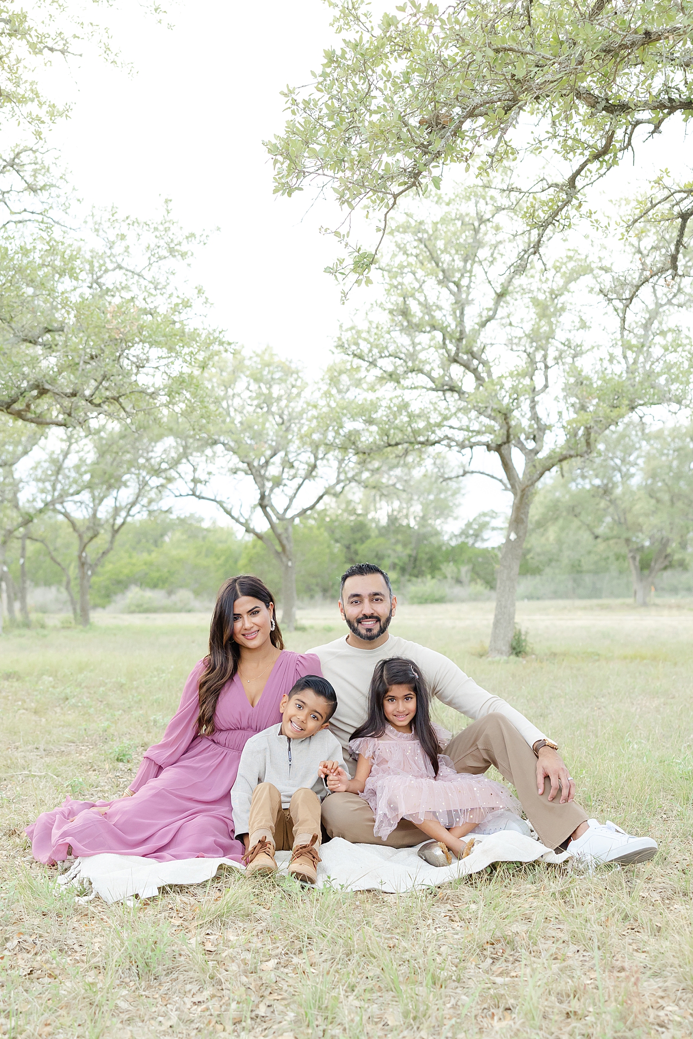 Family sitting on a blanket in the park | Image by Sana Ahmed Photography