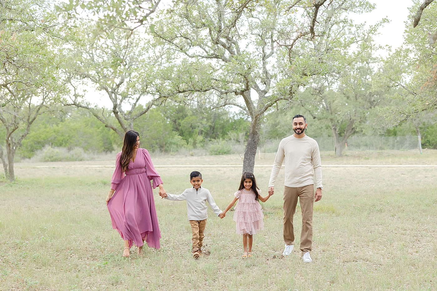 Family of four playing in a field | Image by Sana Ahmed Photography