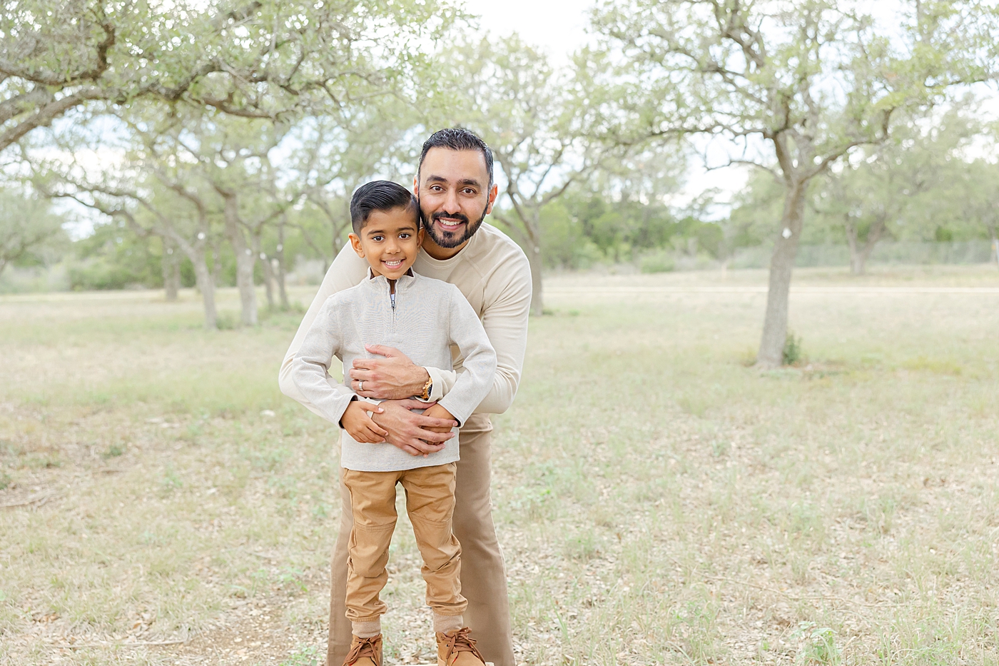 Dad hugging his little boy during their Field Family Session | Image by Sana Ahmed Photography