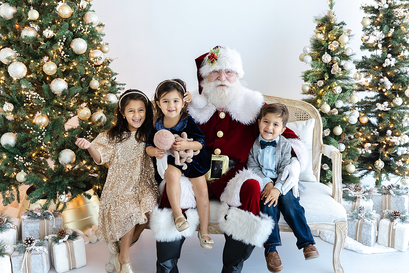 Santa sitting on a sofa with three siblings | Image by Sana Ahmed Photography