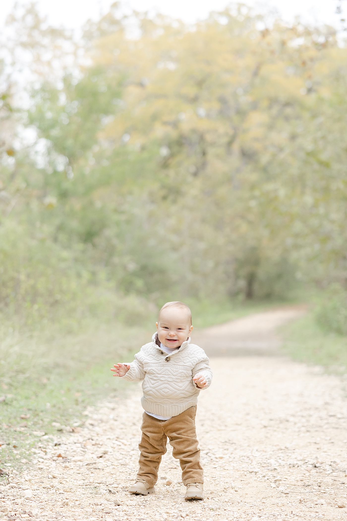 Baby boy standing on a dirt path during their Spring Family Sessions in Austin | Image by Sana Ahmed Photography
