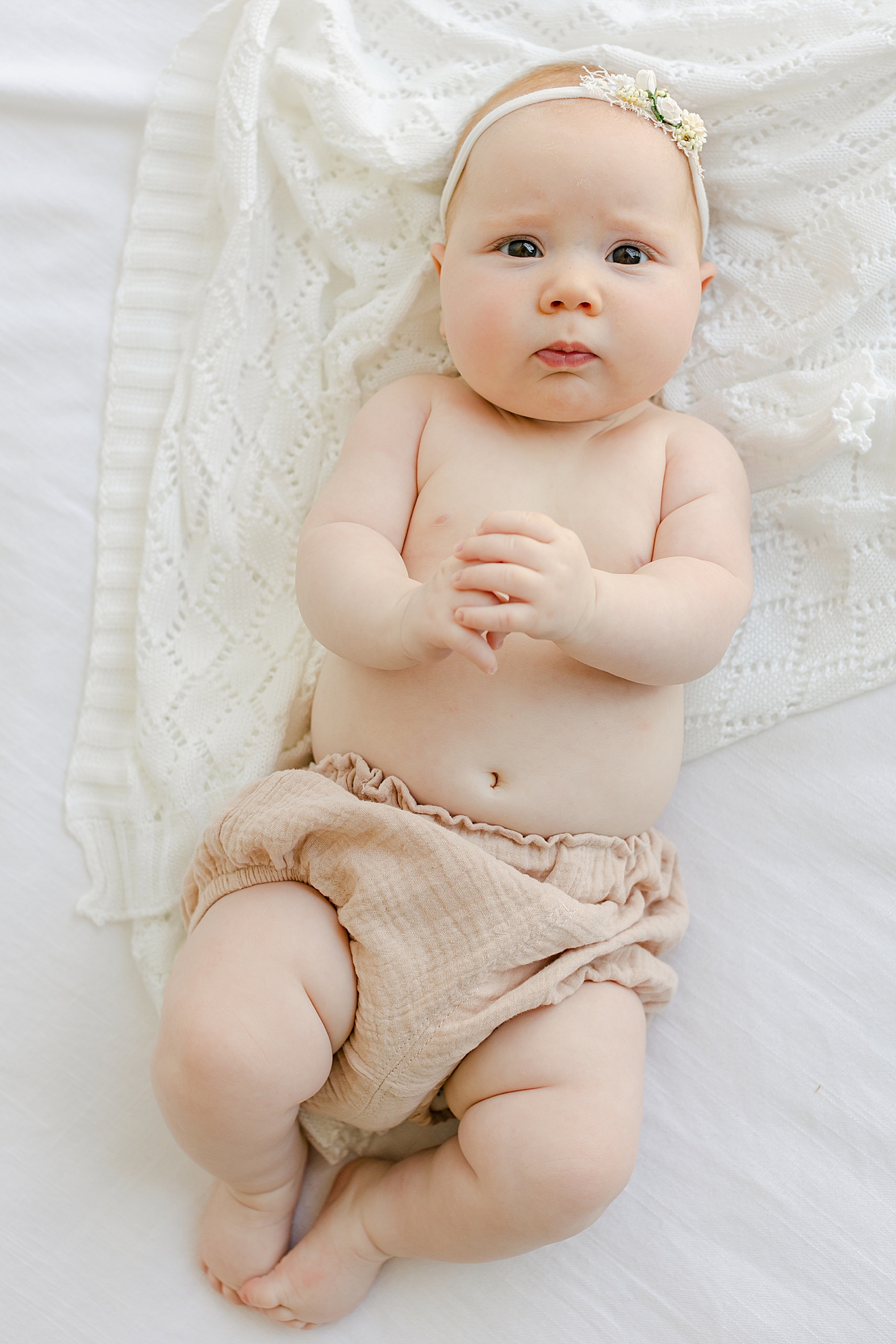 Baby girl in pink bloomers and floral headband | Image by Sana Ahmed Photography