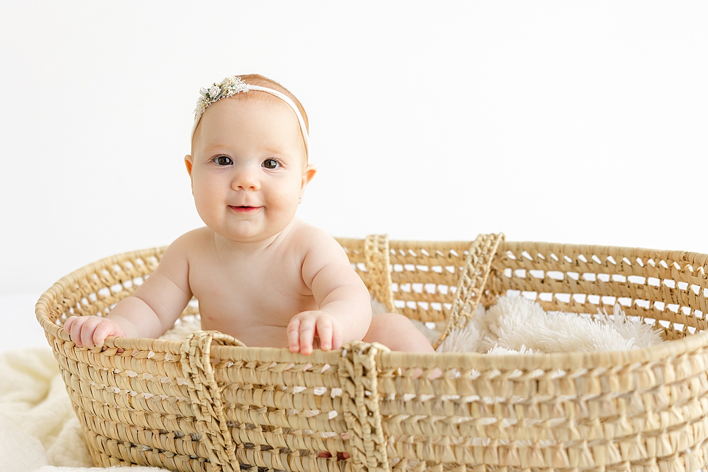 Baby girl in a headband sitting in a headband | Image by Sana Ahmed Photography