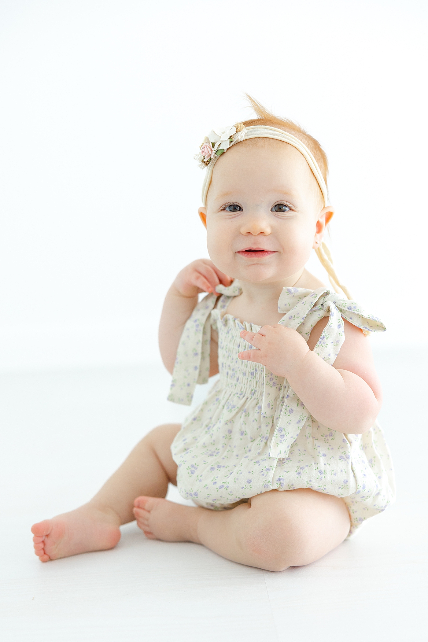 Baby girl in a floral jumpsuit | Image by Sana Ahmed Photography