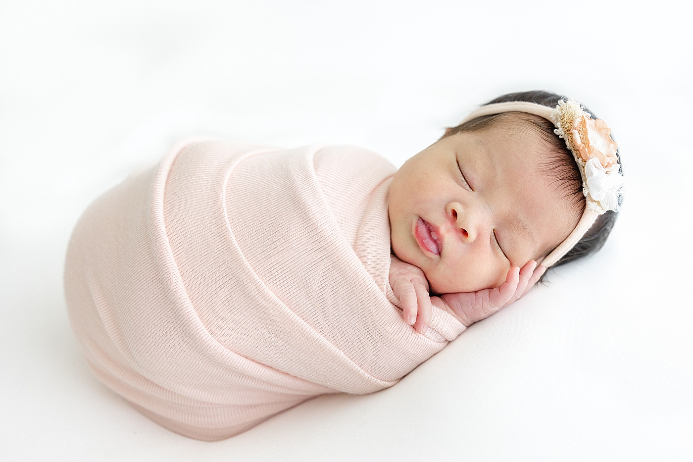 Newborn baby girl wrapped in pink swaddle | Image by Sana Ahmed