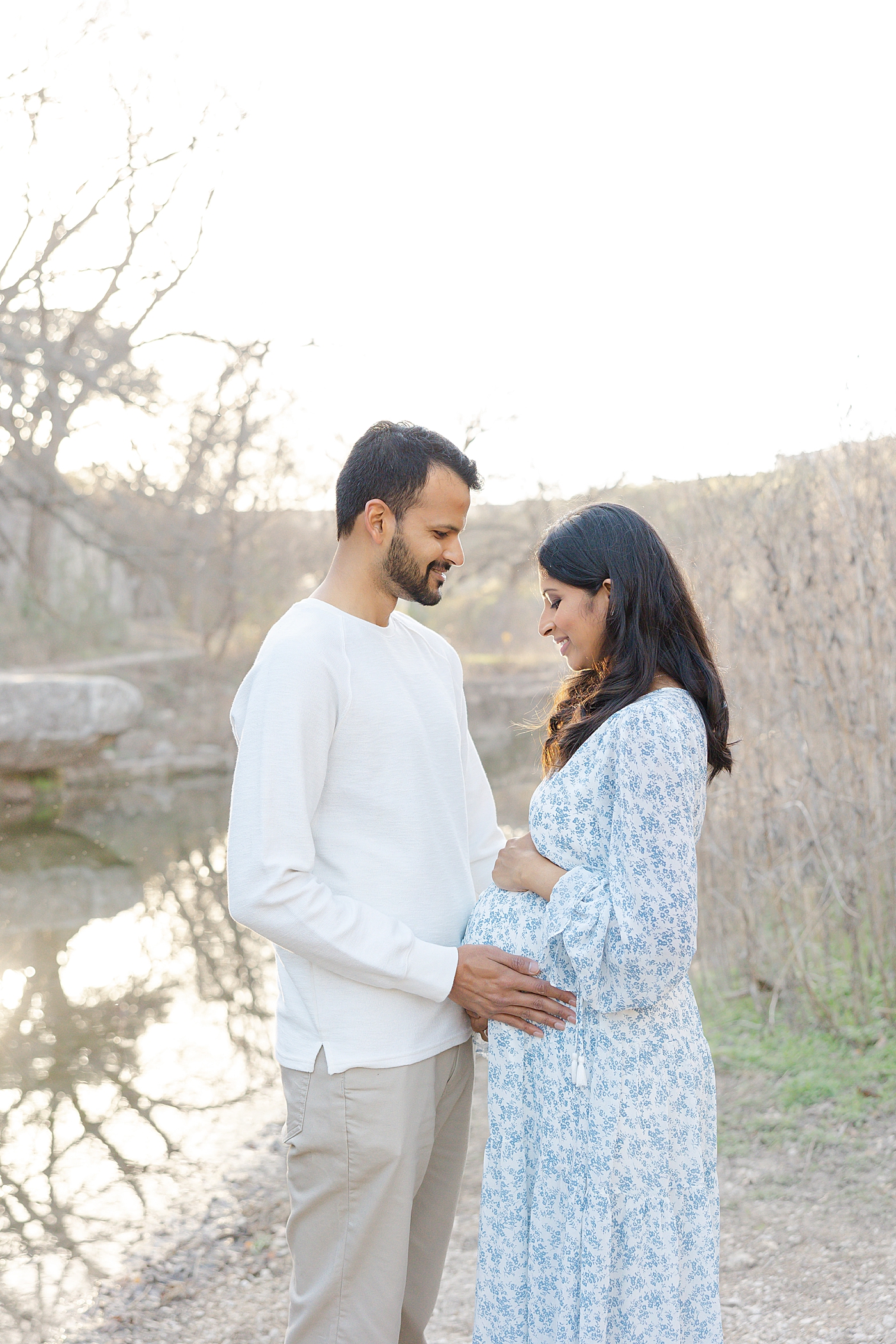 Mom and dad holding mom's belly during their Austin Maternity Session| Images by Sana Ahmed 