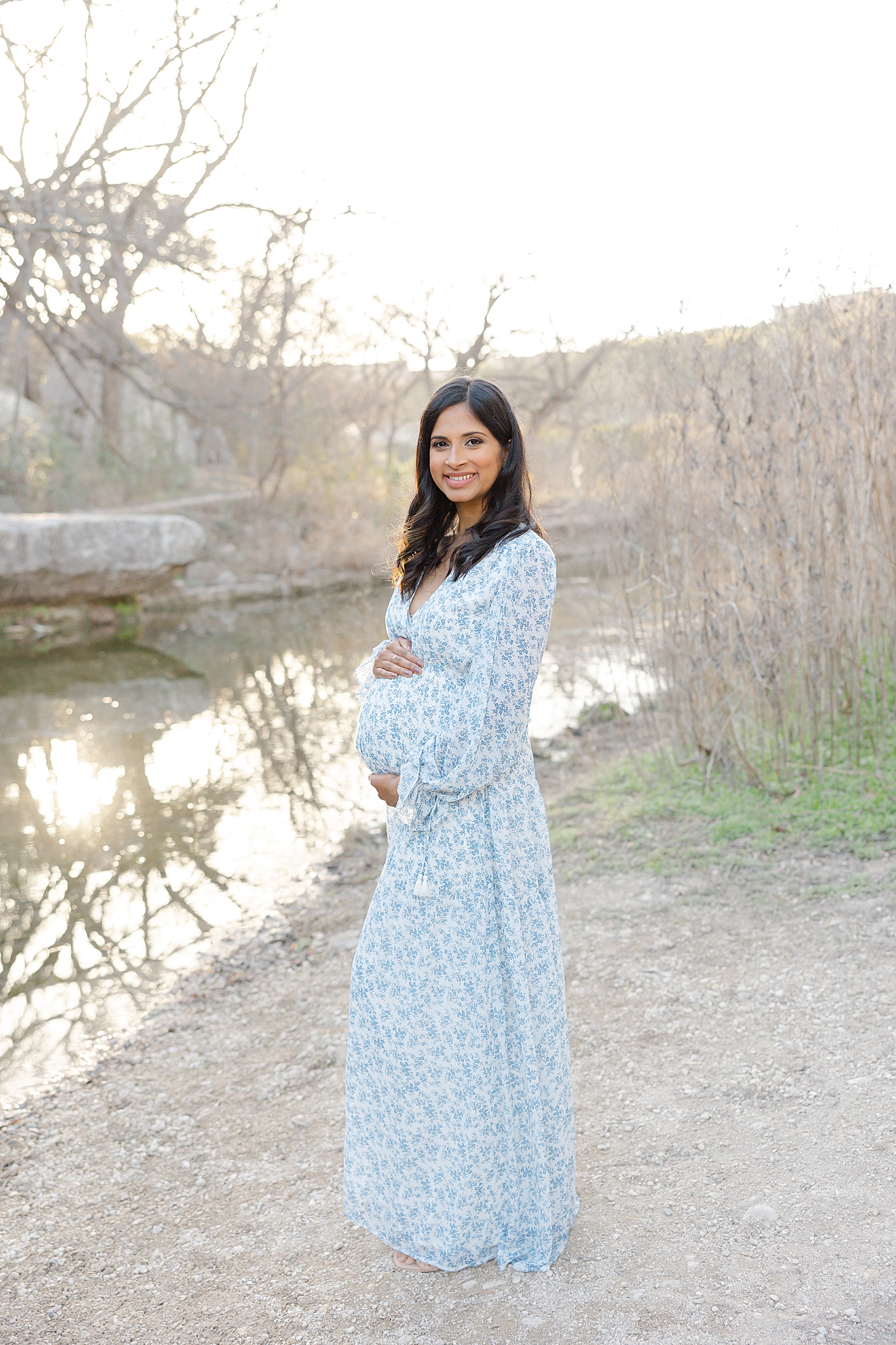 Mom to be in a blue floral dress during their Austin Maternity Session| Images by Sana Ahmed 